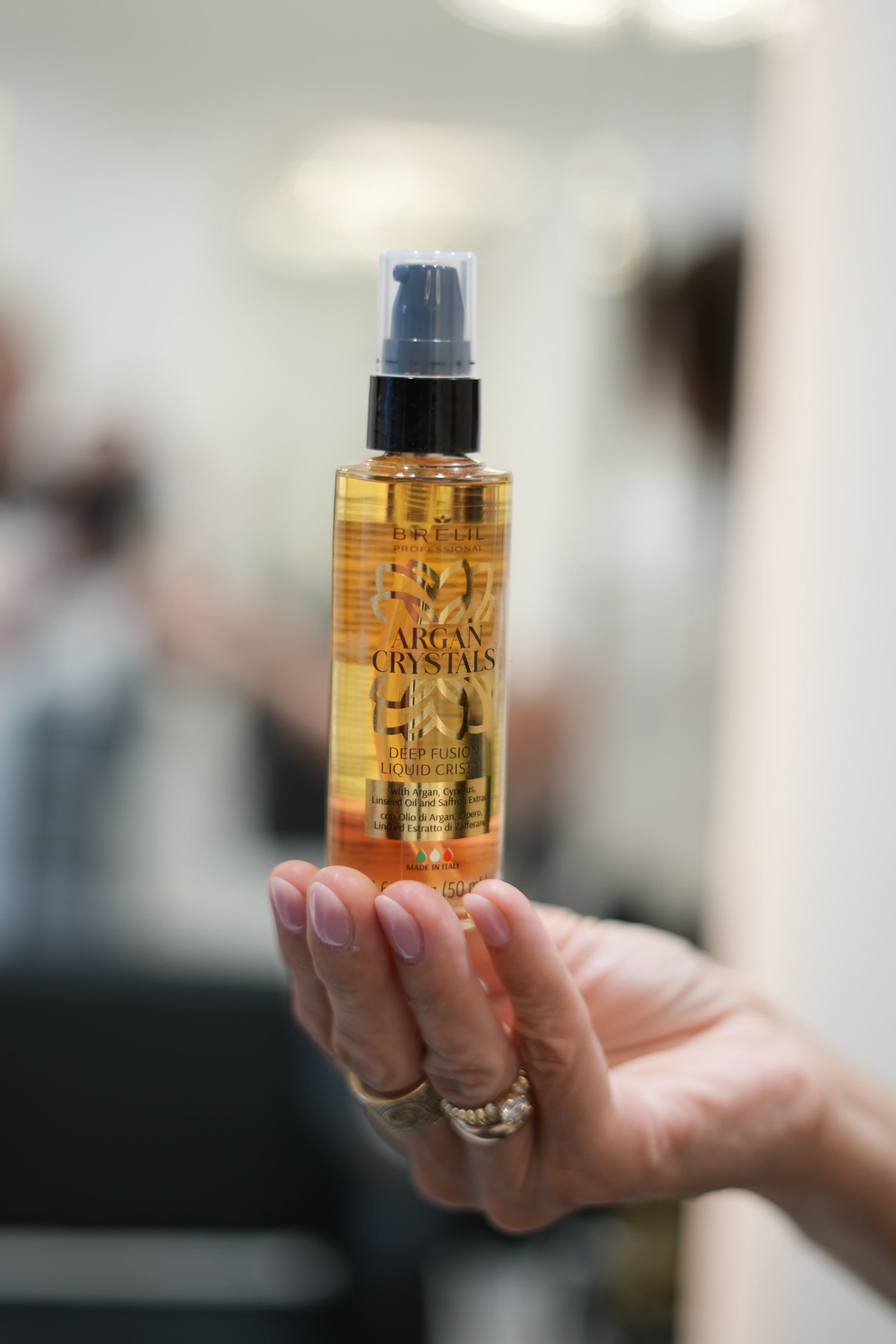 Stylist presenting a hair care product in the salon.